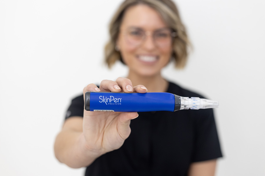 nurse Cander Chance holding SkinPen microneedling device